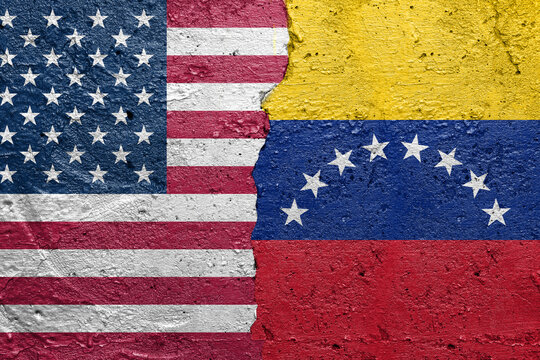 United States of America vs Venezuela - Cracked concrete wall painted with a USA flag on the left and a Venezuelan flag on the right srock photo