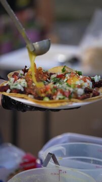 Pastor street tacos, drizzled with green salsa at a California street food vendor. Traditional Mexican food.