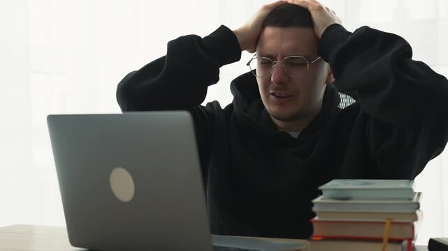 A man feels weak at work.
Fatigue from the heavy workload.
Sore eyes from working on a laptop.