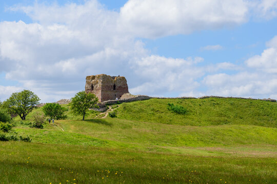 The castle ruins stand on the hill.