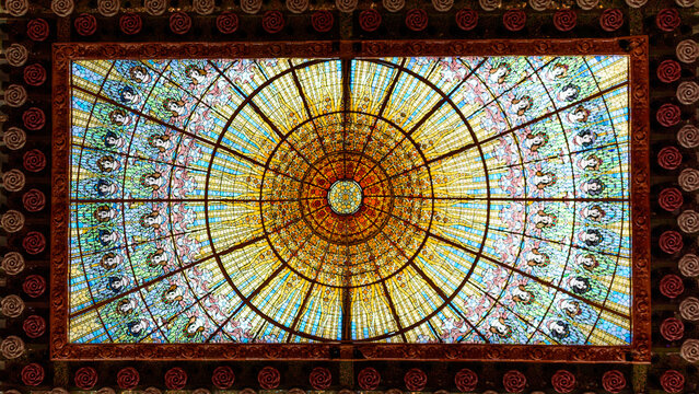 Light streams through a Barcelona stained glass ceiling.