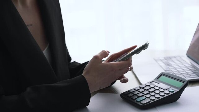 Text preview on a touchscreen phone.
A woman is typing a message to send.
A businesswoman is holding a mobile device.