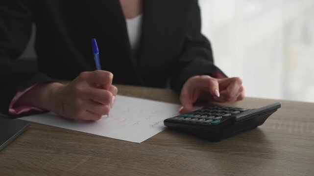 A female accountant uses a calculator while sitting at her desk in the office.
Finance and reporting