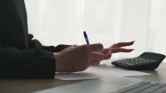 A female accountant uses a calculator while sitting at her desk in the office.
Finance and reporting