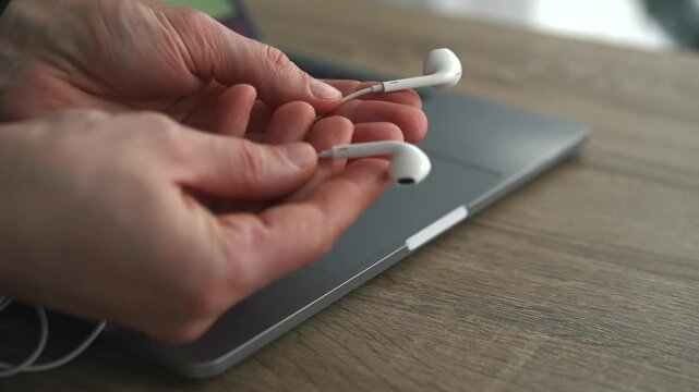 A person holding small wired headphones.
Modern smartphone gadgets