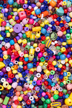 Cheerful Background of Small, Colorful Plastic Beads.