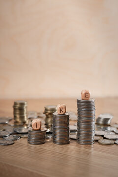 IKE (Indywidualne Konto Emerytalne) Polish Individual Retirement Account concept with rising stacks of Polish zloty coins and wooden letter blocks, showing savings growth and copy space.