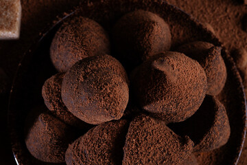 healthy delicious chocolate truffles around cocoa powder.  macro shot