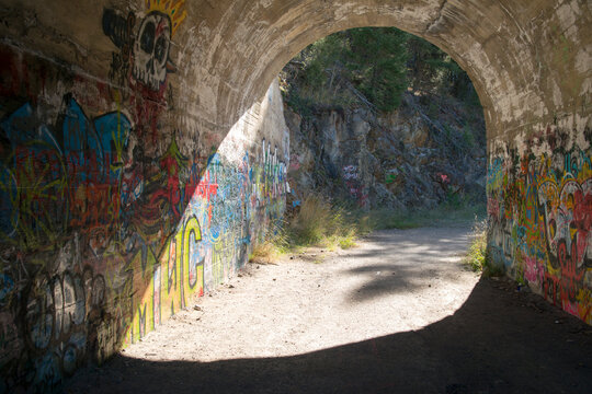 Canada, BC, Greenwood.  Old abandoned one lane road tunnel, Covered in graffiti.