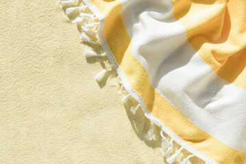 Yellow Beach Towel with Striped Fabric and Tassels. Summer Vacation Flatlay © thayra83