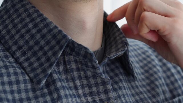 A distinguished man in a business shirt adjusts his collar.
Shirt with a plaid print.
Stylish shirt on a young man.