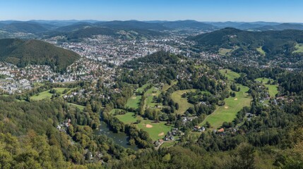 Obraz premium Panoramic View of Lush Green Landscape Overlooking a Scenic Town Surrounded by Rolling Hills and Clear Blue Sky on a Sunny Day