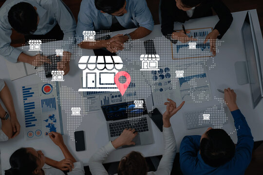 A diverse team of professionals works together at a table, analyzing data and strategizing for business growth with digital maps and charts representing global expansion. Gantry