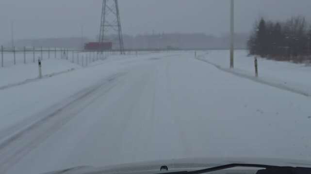 Frosty road with limited visibility. Drive through snow under cloudy overcast sky