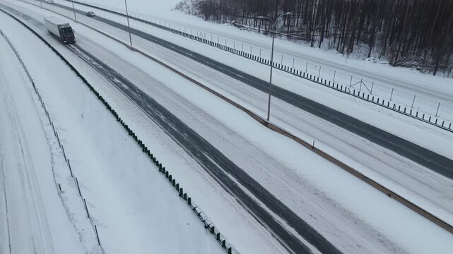 An aircraft swiftly moving through light snowfall highlights urgent cargo delivery conditions