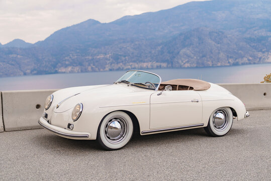 Side view of 1957 Porsche 356 Speedster replica cream classic car convertible with scenic view