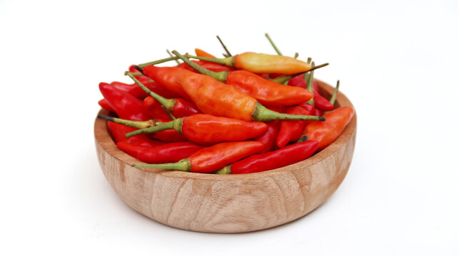 Red cayenne pepper (cabe rawit merah) on wooden bowl isolated on white background