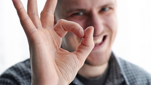 A man makes an OK gesture.
I'm fine.
A gesture of approval.