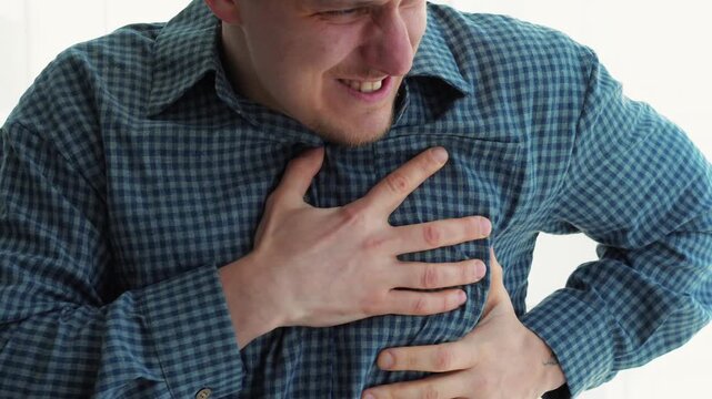 Heart attack in a guy in a plaid blue shirt.