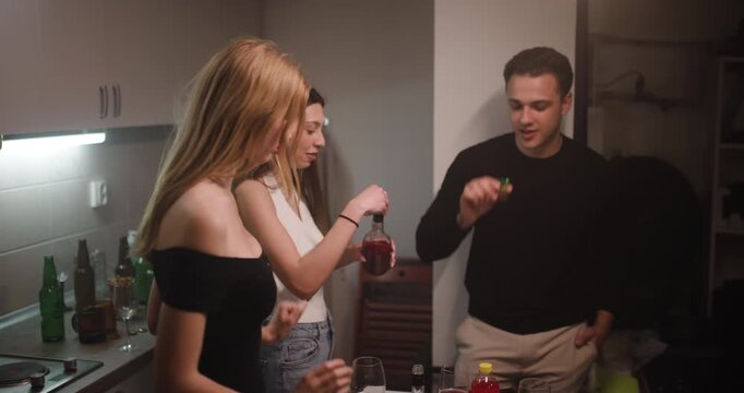 Young Adults Having Fun at a House Party, Drinking Shots and Celebrating with Friends
