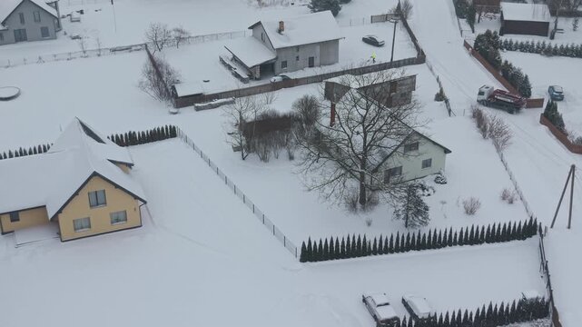 Rural homestead under winter sky. Quiet rural residence with snowcovered outbuildings and frosted trees