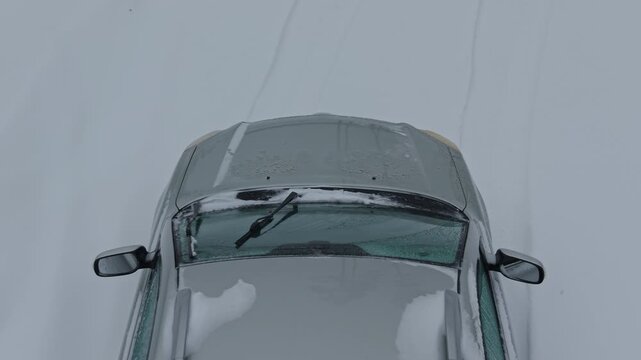 Snowcovered vehicle in peaceful morning. Quiet winter morning showing icy car with faint tire tracks