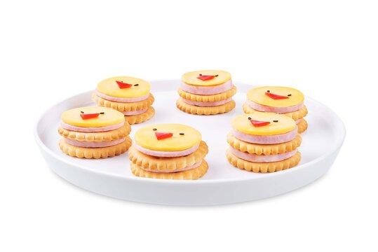 Ham sausage and cheese slices in the form of chick and crackers on a white isolated background