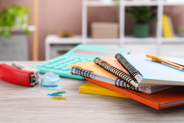Homework. Notebooks and stationery on wooden desk, closeup