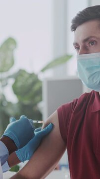 Doctor administering vaccine in clinic, Closeup of vaccination process performed by healthcare professional