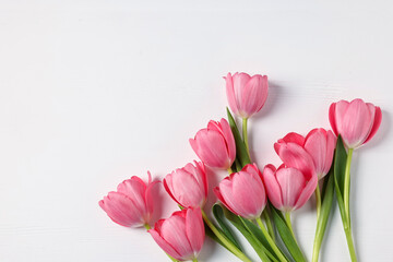 Obraz premium Beautiful pink tulips on white table, flat lay. Space for text