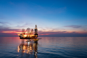 Aerial view of offshore jack up rig in a shipyard during sunset for oil and gas exploration and...
