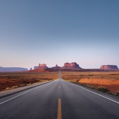Endless road leading to monument valley at sunrise