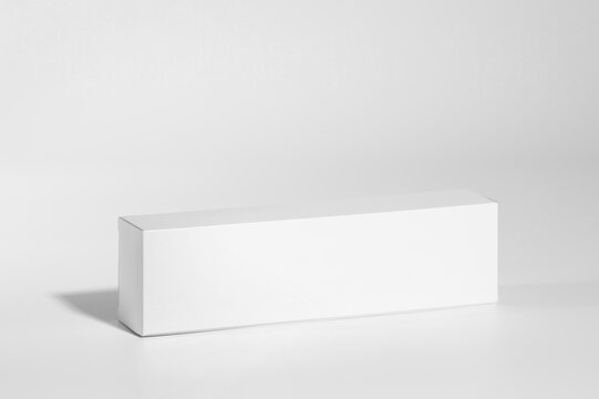 Mockup of a long white box of parapharmacy product, standing, includes tracing