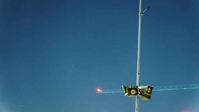 Comet Lemmon crossing the night sky with a crane