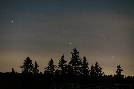 Comet Lemmon, Starlink satellites and airplanes moving across the night sky