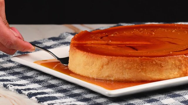 Close-up of a slice of flan or known as flan napolitano served with a spatula