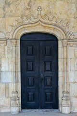 Portugal, Lisbon - 05 Aug 2018: Antique Black Wooden Double Door Gothic Arch
