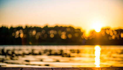 A reflection of the sunset on a river or stream, with a blurred golden bokeh background of a forest.