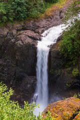 Obraz premium Elk Falls waterfall flowing through steep rock walls in a forested setting on Vancouver Island, British Columbia