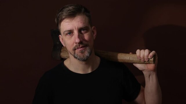Brutal man with ax on color background