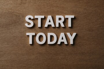 Naklejka premium Start Today Typography on Wooden Background Encouraging Action and Motivation for Success, Inspiration