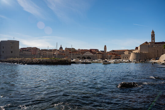 Dubrovnik Croatia aerial view of historic old town harbour port with yachts and fortress.
