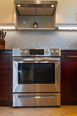 Stainless steel electric range oven in modern kitchen