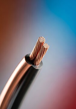 Extreme close up of perfectly stripped, shiny copper electrical wire, highlighting quality preparation, strong conductivity, and engineering, electrical, power, conductor