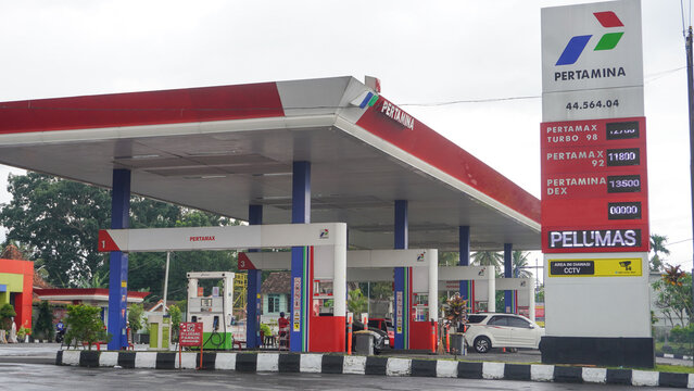 The situation at the pertamina gas station or spbu saw lots of cars and trucks queuing up to refuel. A filling station, also known as petrol or gas station. Car, truck, motorcycle. Boyolali, Indonesia