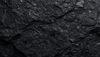 Fototapeta premium Close up of dark grey rock texture reveals rough surface with small white spots