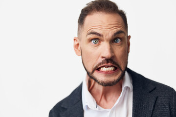 Obraz premium A business professional man on a colored isolated background, displaying intense emotion with raised eyebrows and clenched teeth, ready for bold presentation and clear communication.
