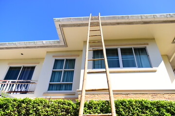 wood ladder for repair house's gutter before rainy season