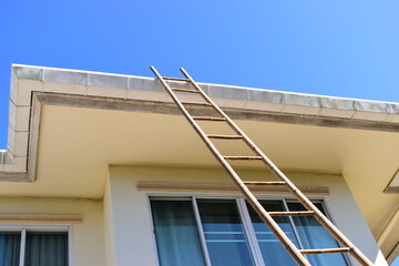 wood ladder for repair house's gutter before rainy season