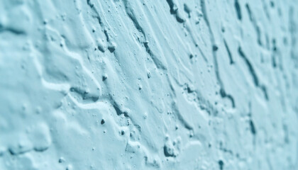 Abstract Light Blue Stucco Wall Texture Background. Close-up of rough cement render with uneven surface and deep shadows in teal color saturation. © Adrian Syauqi